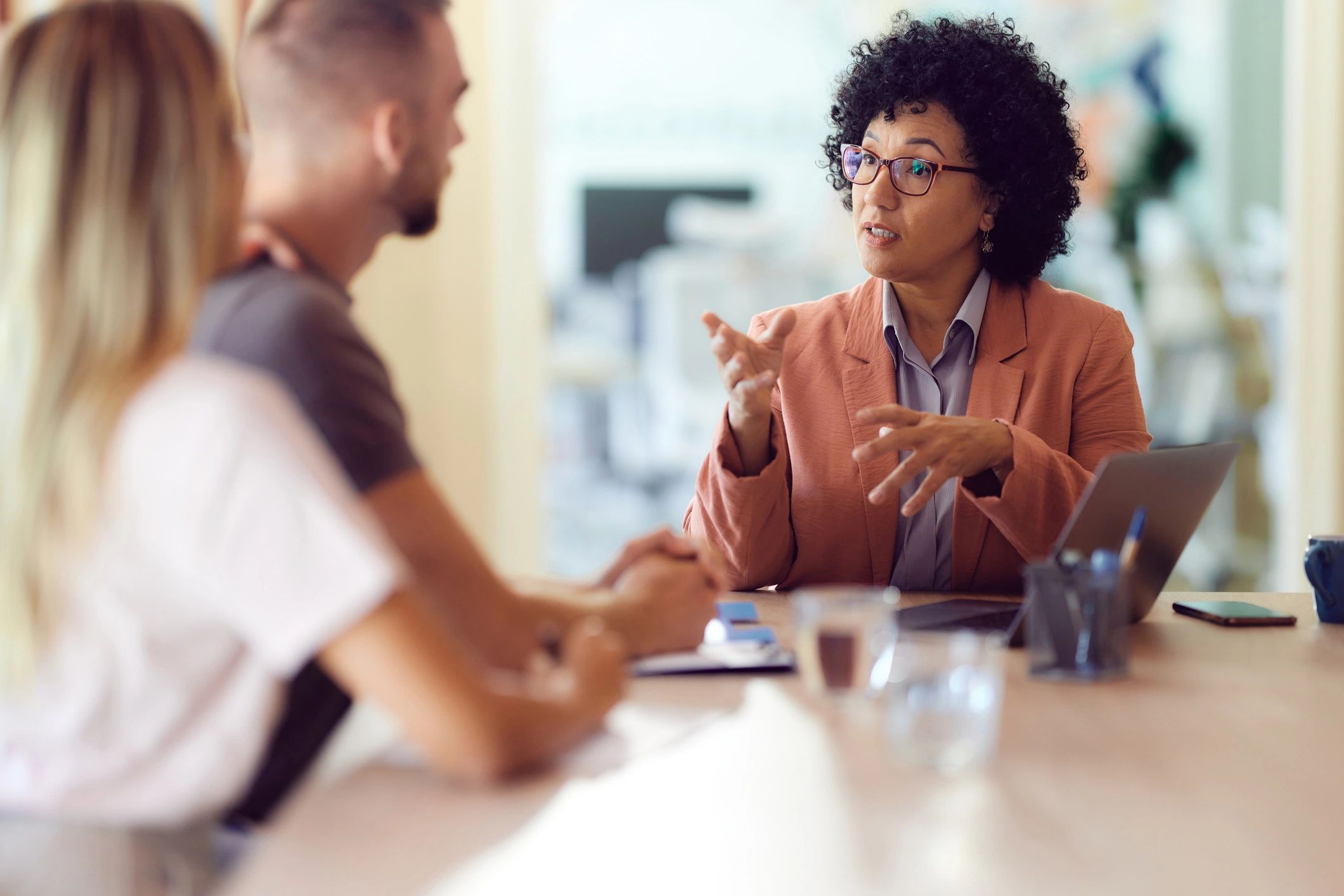 Advisor speaking with clients during a project financing meeting