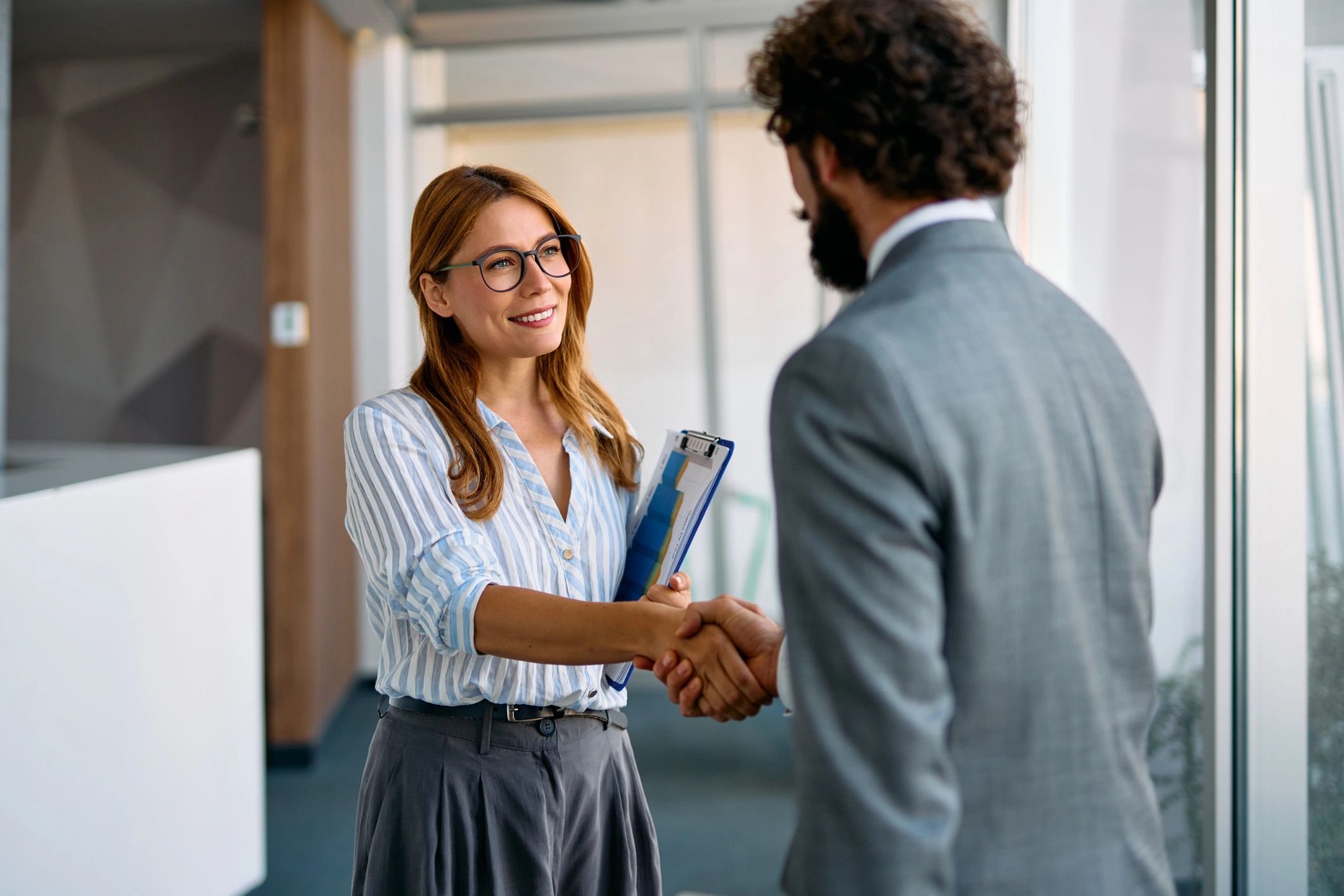 Two professionals shaking hands after reaching an agreement